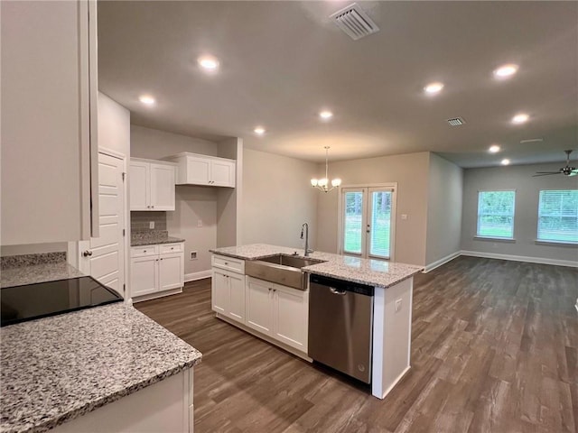 kitchen featuring an island with sink, white cabinets, stainless steel dishwasher, and light stone counters