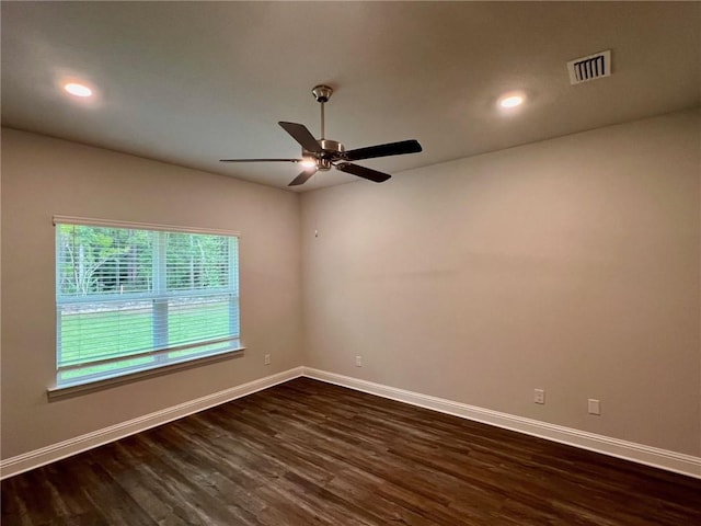 unfurnished room featuring ceiling fan and dark wood-type flooring