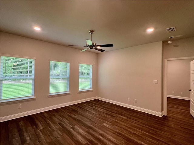 empty room with ceiling fan and dark hardwood / wood-style flooring