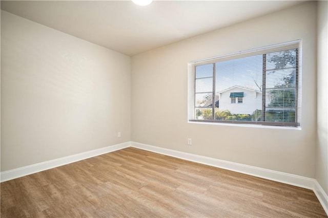 empty room featuring light wood-style floors and baseboards