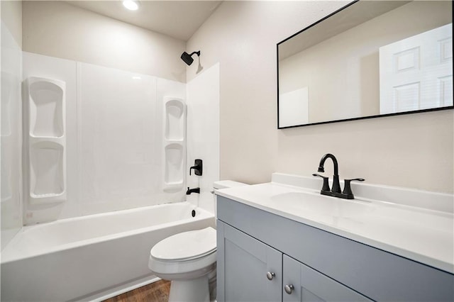 full bath featuring vanity, toilet, shower / tub combination, and wood finished floors