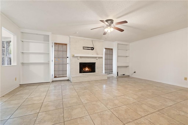 unfurnished living room featuring a brick fireplace, a textured ceiling, light tile patterned floors, built in features, and ceiling fan