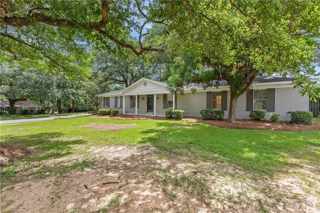 ranch-style house with a porch and a front lawn