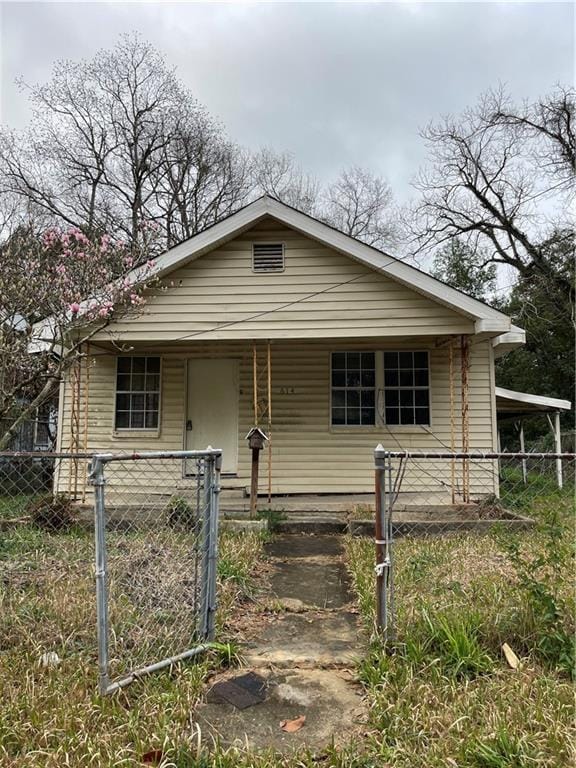 bungalow-style home with a fenced front yard