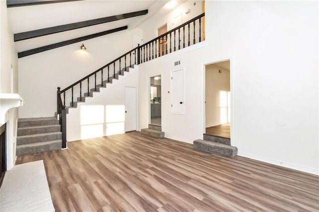 9636 Hamilton Creek Dr S, Mobile, AL 36695 - unfurnished living room featuring stairway, wood finished floors, high vaulted ceiling, and beamed ceiling