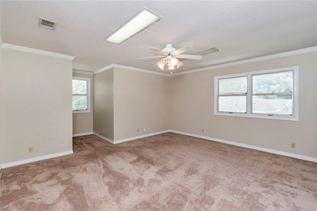 carpeted spare room with ceiling fan and ornamental molding