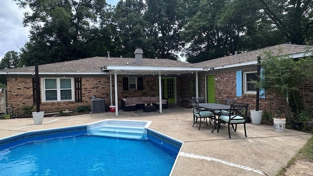 6980 Charmingdale Dr S, Mobile, AL 36618 - back of house with an outdoor living space, a patio, brick siding, an outdoor pool, and central air condition unit