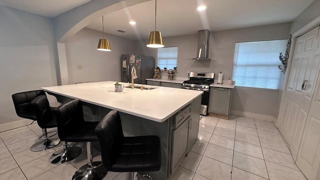 6980 Charmingdale Dr S, Mobile, AL 36618 - kitchen with gas range, wall chimney exhaust hood, black refrigerator with ice dispenser, gray cabinetry, and light tile patterned flooring