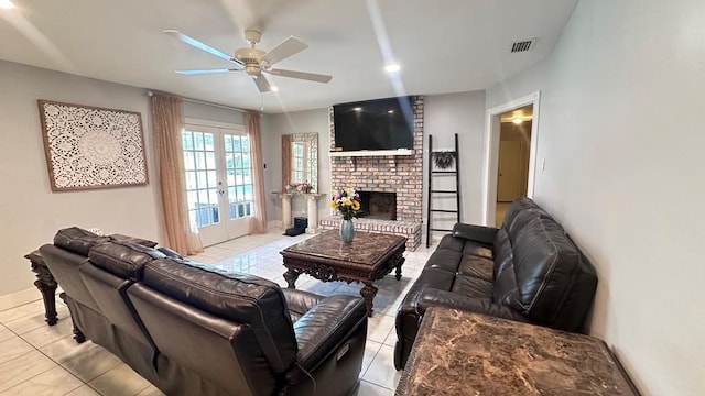 6980 Charmingdale Dr S, Mobile, AL 36618 - tiled living room featuring ceiling fan, french doors, a brick fireplace, and baseboards