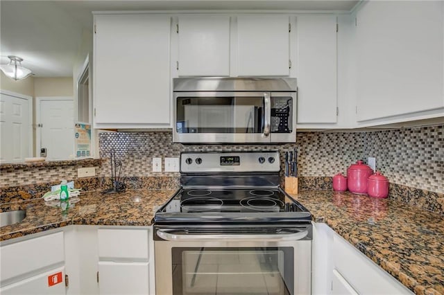 6194 State Highway 59 Unit D-8, Gulf Shores, AL 36542 - kitchen with stainless steel appliances, white cabinetry, tasteful backsplash, and dark stone countertops