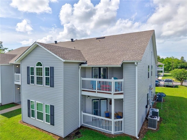 6194 State Highway 59 Unit D-8, Gulf Shores, AL 36542 - rear view of property featuring a balcony, a yard, central air condition unit, and a shingled roof
