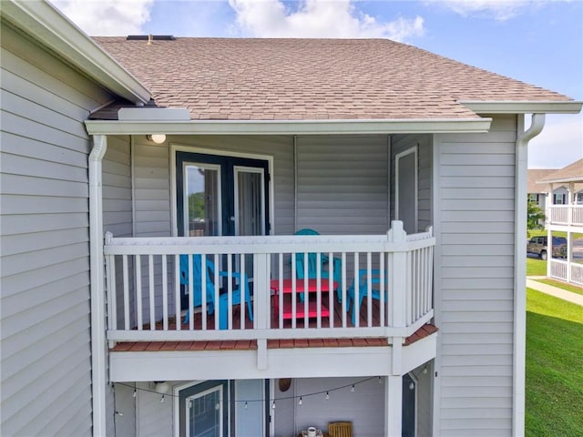6194 State Highway 59 Unit D-8, Gulf Shores, AL 36542 - rear view of house featuring a shingled roof and a balcony
