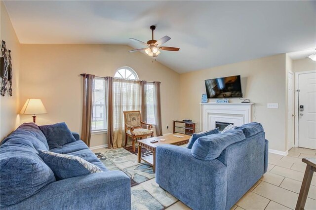 6194 State Highway 59 Unit D-8, Gulf Shores, AL 36542 - living area featuring a ceiling fan, lofted ceiling, a fireplace, light tile patterned floors, and baseboards