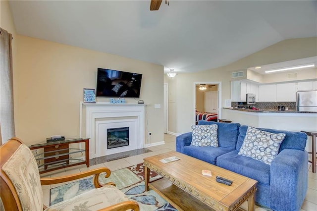 6194 State Highway 59 Unit D-8, Gulf Shores, AL 36542 - living room with ceiling fan, light tile patterned floors, a fireplace with flush hearth, lofted ceiling, and baseboards