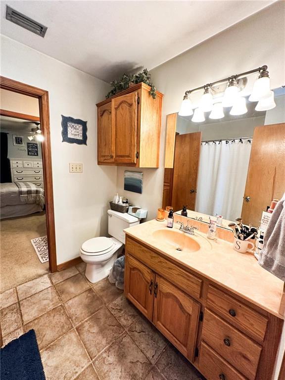 bathroom with toilet and vanity