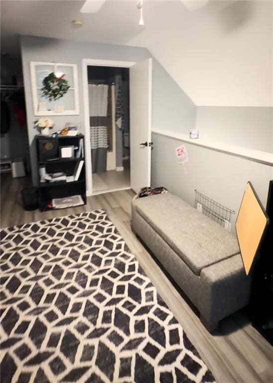 living room with vaulted ceiling and wood-type flooring