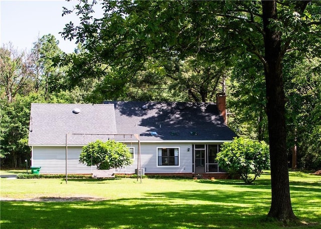 back of house with a lawn