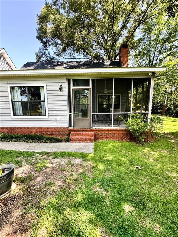 view of front of property with a front lawn and a sunroom