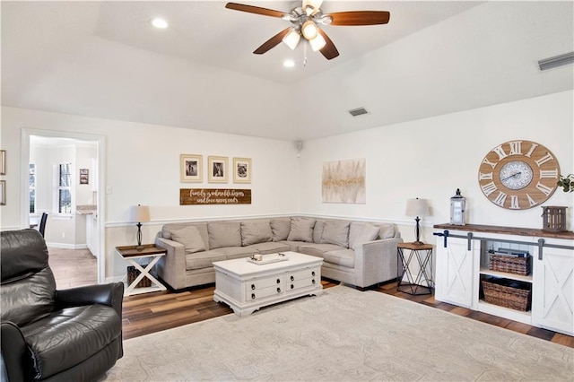 living room featuring recessed lighting, wood finished floors, and visible vents