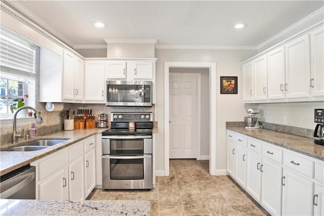 kitchen featuring a sink, ornamental molding, stainless steel appliances, white cabinetry, and tasteful backsplash