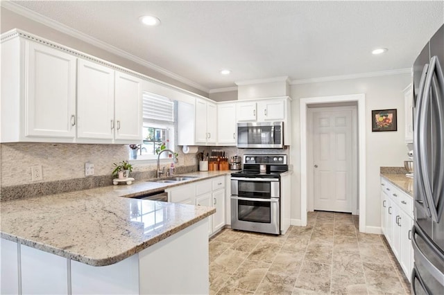 kitchen with a sink, backsplash, stainless steel appliances, a peninsula, and white cabinets