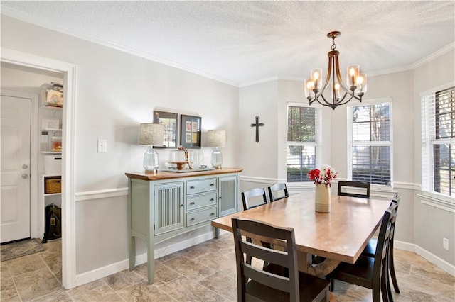 dining room with ornamental molding, a chandelier, and a textured ceiling