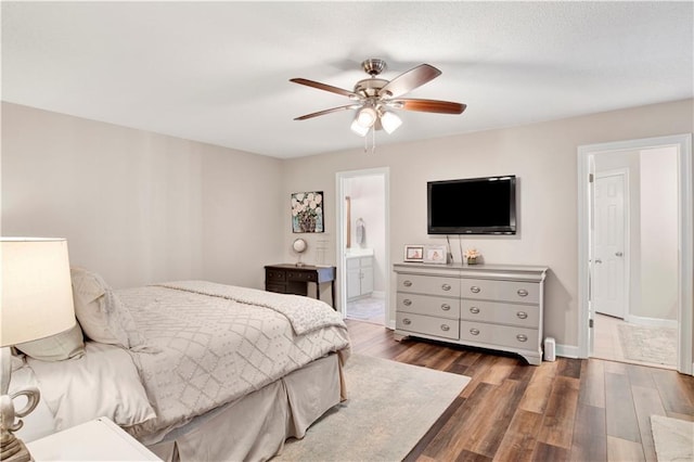 bedroom featuring connected bathroom, ceiling fan, baseboards, and wood finished floors