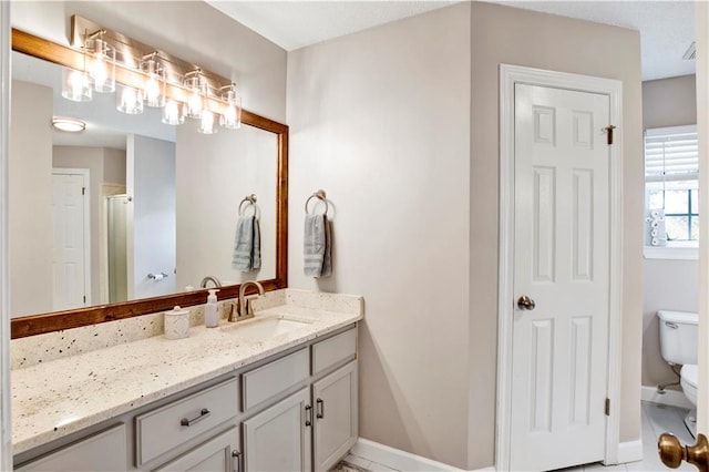 full bathroom with vanity, toilet, baseboards, and an enclosed shower