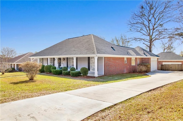 view of front of home with a front lawn, a porch, fence, a garage, and brick siding