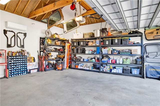 garage with a garage door opener and a wall mounted AC