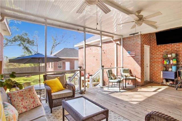 sunroom with a ceiling fan