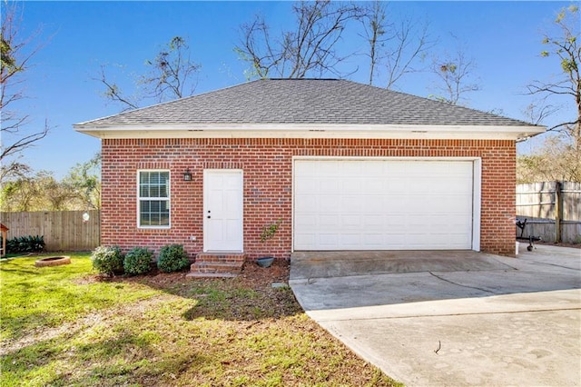 view of front of property featuring brick siding, driveway, and fence