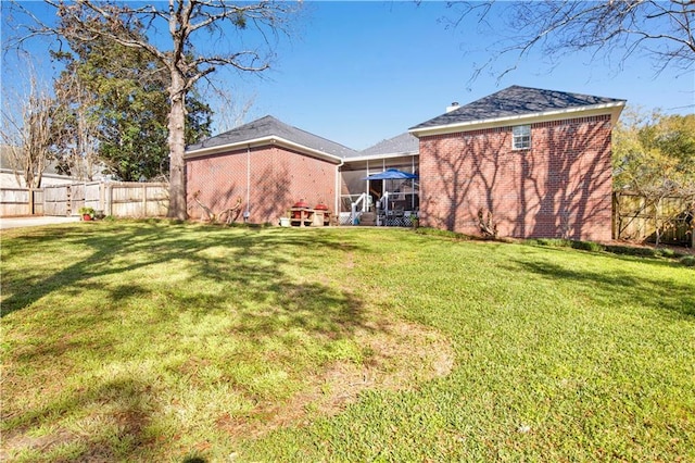 view of yard featuring fence and a sunroom