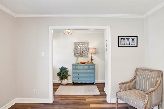 sitting room with baseboards, wood finished floors, and ornamental molding