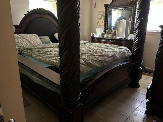 tiled bedroom with multiple windows