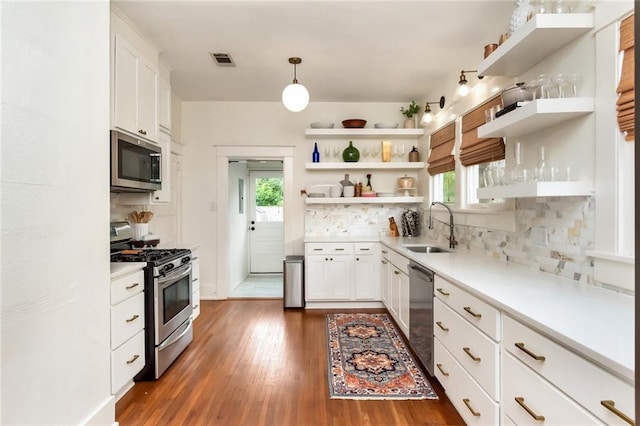 kitchen featuring a sink, appliances with stainless steel finishes, visible vents, and open shelves