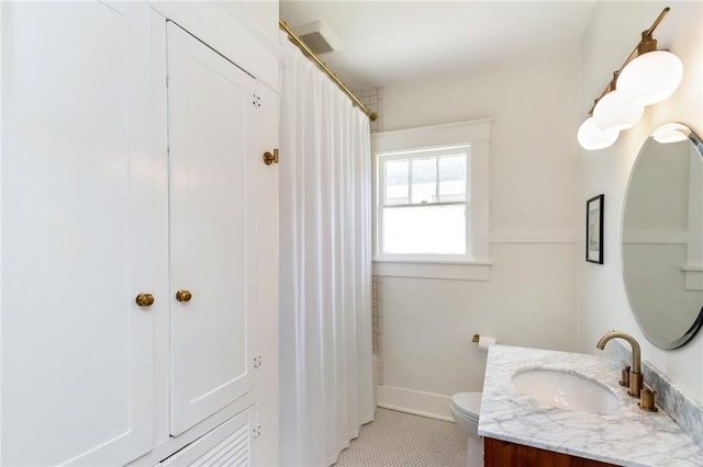 bathroom with toilet, curtained shower, tile patterned flooring, baseboards, and vanity