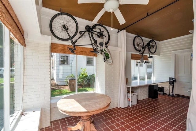 sunroom / solarium featuring ceiling fan