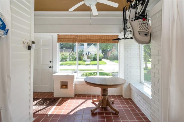 sunroom / solarium featuring ceiling fan