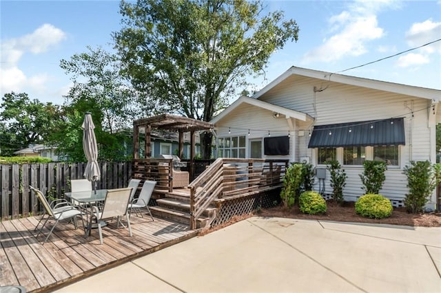 rear view of property featuring crawl space, a pergola, outdoor dining area, and a deck