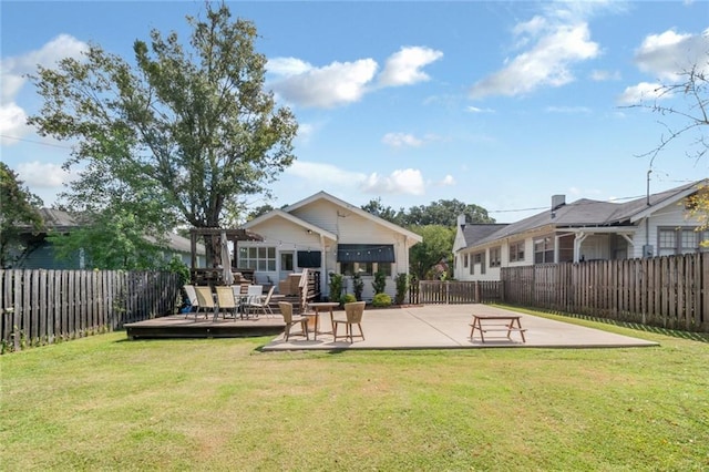 back of house featuring a yard, a fenced backyard, and a pergola