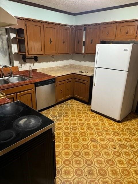 kitchen with sink, a textured ceiling, electric range oven, stainless steel dishwasher, and white fridge