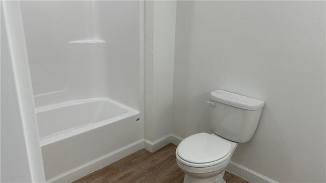 bathroom with toilet and wood-type flooring