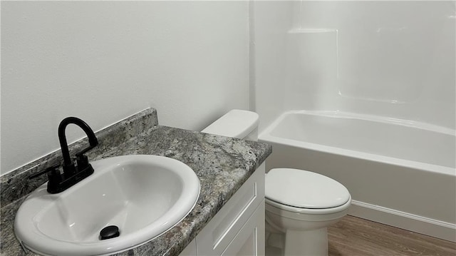 bathroom with hardwood / wood-style floors, vanity, and toilet