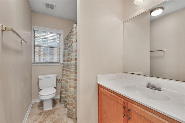 bathroom with tile floors, toilet, and vanity