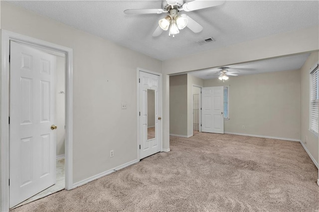 unfurnished room with ceiling fan and light colored carpet