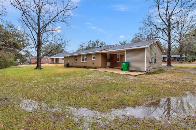 rear view of property with a yard and a patio