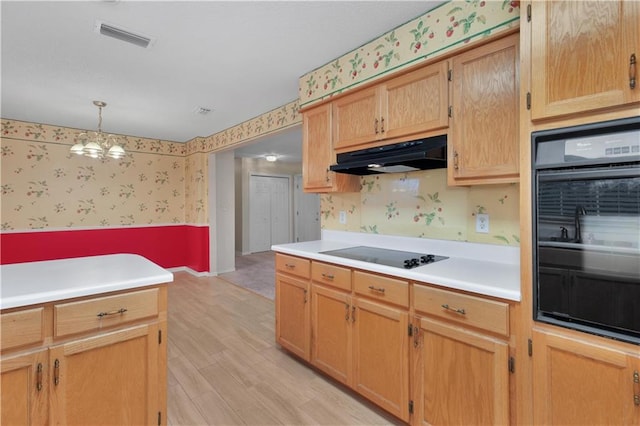 kitchen featuring light hardwood / wood-style floors, pendant lighting, a chandelier, and black appliances