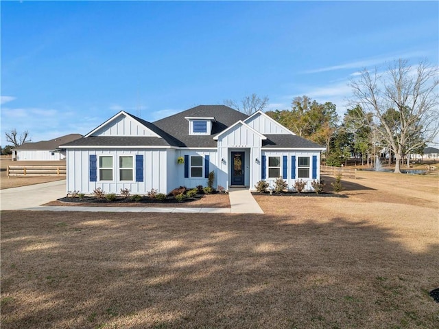 modern inspired farmhouse with a front lawn