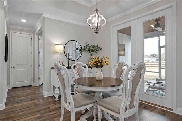 dining room featuring ornamental molding, dark hardwood / wood-style floors, and a chandelier